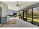 Enclosed patio with ceiling fan overlooking the manicured lawn and garden at 2630 Moss Oak Dr # 50, Sarasota, FL 34231
