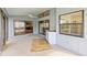 Screened-in patio features a ceiling fan, and sliding glass doors to the home's interior at 2630 Moss Oak Dr # 50, Sarasota, FL 34231