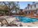 Sparkling pool with brick patio and lounge chairs, perfect for relaxation and entertaining at 2630 Moss Oak Dr # 50, Sarasota, FL 34231