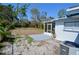 The backyard features trees, landscaping, a concrete patio and an exterior view of the screened in porch at 321 40Th Street Nw Ct, Bradenton, FL 34209