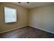Simple bedroom with wood-look floors and a window at 321 40Th Street Nw Ct, Bradenton, FL 34209
