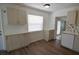 Well-lit kitchen with stainless steel appliances, ample cabinet space, and vinyl wood floors at 321 40Th Street Nw Ct, Bradenton, FL 34209