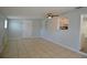 Comfortable living room with tile flooring, a ceiling fan, and connection to kitchen at 321 40Th Street Nw Ct, Bradenton, FL 34209