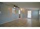 Bright living room featuring tile flooring, a ceiling fan, and glass panel back door at 321 40Th Street Nw Ct, Bradenton, FL 34209