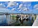 Scenic view of the waterfront featuring boats, docks, and clear blue skies with fluffy clouds at 321 40Th Street Nw Ct, Bradenton, FL 34209
