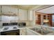 Bright kitchen with white cabinets, standard appliances, and a view into the adjacent living area at 3365 7Th St, Sarasota, FL 34237
