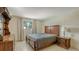 Bedroom with hardwood furniture and a large bed, complemented by natural light from the window at 3365 7Th St, Sarasota, FL 34237