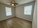 Cozy bedroom with neutral walls, two windows offering natural light, and a ceiling fan at 3707 Carroway St, Tampa, FL 33619