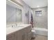 Bright bathroom featuring a large mirror and tiled shower/tub combo at 3783 Beneva Oaks Blvd, Sarasota, FL 34238