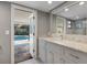 Bright bathroom featuring granite countertops and access to a screened pool area for added convenience at 3783 Beneva Oaks Blvd, Sarasota, FL 34238