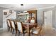 Dining area featuring a large wood table, modern chandelier, and views of the foyer at 3783 Beneva Oaks Blvd, Sarasota, FL 34238