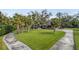 Beautiful home featuring lush green lawn, mature palm trees, and a long driveway at 3783 Beneva Oaks Blvd, Sarasota, FL 34238