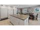 Open kitchen and dining area with a large island and stainless steel appliances at 3783 Beneva Oaks Blvd, Sarasota, FL 34238