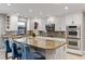 Bright kitchen with a large center island, white cabinetry, and stainless steel appliances at 3783 Beneva Oaks Blvd, Sarasota, FL 34238