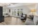Well-lit living area featuring hardwood floors and multiple access points to the outside at 3783 Beneva Oaks Blvd, Sarasota, FL 34238