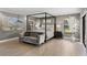 Main bedroom features neutral decor, sitting area and a four-poster bed at 3783 Beneva Oaks Blvd, Sarasota, FL 34238