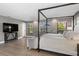 Spacious bedroom with a four-poster bed, sitting area and lots of natural light at 3783 Beneva Oaks Blvd, Sarasota, FL 34238