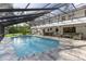 Stunning view of the screened pool and deck area with an upper-level balcony overlooking the space at 3783 Beneva Oaks Blvd, Sarasota, FL 34238