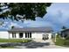 Single-story home with a well-maintained lawn, gray roof, and a boat parked on the driveway at 5174 Conner Ter, Port Charlotte, FL 33981