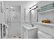 Clean bathroom featuring tiled shower, modern vanity, and ample storage at 5279 Isla Key S Blvd # 113, St Petersburg, FL 33715