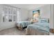 Bright bedroom featuring twin beds, shutters, and beachy decor at 5279 Isla Key S Blvd # 113, St Petersburg, FL 33715