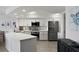 Modern kitchen features white cabinets, stainless appliances, quartz counters, and mosaic tile backsplash at 5279 Isla Key S Blvd # 113, St Petersburg, FL 33715