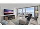 Open living space with full ocean views, comfortable seating and a wall-mounted television over an electric fireplace at 5279 Isla Key S Blvd # 113, St Petersburg, FL 33715