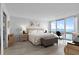 Inviting primary bedroom with water views, neutral tones, tiled floors, a writing desk, and ample natural light at 5279 Isla Key S Blvd # 113, St Petersburg, FL 33715