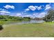 Expansive lake view with lush green lawn and beautiful trees, creating a serene outdoor setting at 5974 San Michelle Dr, Sarasota, FL 34243