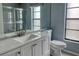 Modern bathroom with a sleek vanity, large mirror, and a water-efficient toilet at 5974 San Michelle Dr, Sarasota, FL 34243