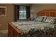 Comfortable bedroom featuring a wooden bed frame and a view of the outdoors at 5974 San Michelle Dr, Sarasota, FL 34243