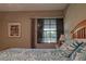 Comfortable bedroom with a wooden bed frame and a large window at 5974 San Michelle Dr, Sarasota, FL 34243