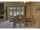 Dining area featuring a view of the lake, a fireplace, and lots of natural light at 5974 San Michelle Dr, Sarasota, FL 34243
