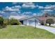 Charming one-story home with light blue garage door, mature landscaping and tile roof at 5974 San Michelle Dr, Sarasota, FL 34243