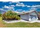 Charming one-story home with light blue garage door, mature landscaping and tile roof at 5974 San Michelle Dr, Sarasota, FL 34243