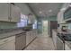 Bright kitchen featuring stainless appliances, granite counters, and tile flooring at 5974 San Michelle Dr, Sarasota, FL 34243