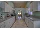 Spacious kitchen with white cabinets, granite counters, stainless appliances and tile floor at 5974 San Michelle Dr, Sarasota, FL 34243