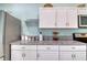 Charming kitchen featuring white cabinets and granite countertops at 5974 San Michelle Dr, Sarasota, FL 34243