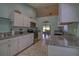 Bright kitchen with white cabinets, granite counters, and stainless steel appliances at 5974 San Michelle Dr, Sarasota, FL 34243