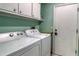 Functional laundry room with washer, dryer, and storage cabinets at 5974 San Michelle Dr, Sarasota, FL 34243