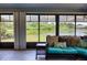 Cozy sunroom with wicker furniture and tranquil views of the lake, perfect for relaxing and enjoying the scenery at 5974 San Michelle Dr, Sarasota, FL 34243