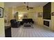 Spacious living room with tile floors, ceiling fan, fireplace, and comfortable leather sofas, creating an inviting atmosphere at 5974 San Michelle Dr, Sarasota, FL 34243