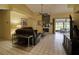 Bright living room with tile floors, ceiling fan, fireplace, and comfortable sofas, perfect for relaxation and entertaining at 5974 San Michelle Dr, Sarasota, FL 34243