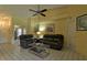 Inviting living room featuring a ceiling fan, tile flooring, comfortable seating, and ample natural light at 5974 San Michelle Dr, Sarasota, FL 34243
