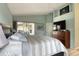 Spacious main bedroom featuring a large bed, a TV, and access to a lanai at 5974 San Michelle Dr, Sarasota, FL 34243