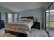 Spacious main bedroom with neutral-toned bedding, a large bed frame, and access to a lanai at 5974 San Michelle Dr, Sarasota, FL 34243
