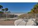 An incredible beach view from a seating area with ocean views and palm trees at 6512 Midnight Pass Rd # 206, Sarasota, FL 34242