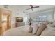 Bright bedroom features two beds, a ceiling fan, and a dresser with a TV for added comfort at 6512 Midnight Pass Rd # 206, Sarasota, FL 34242