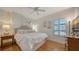 Inviting bedroom with a plush bed, hardwood floors, plantation shutters, and soft, natural light at 6512 Midnight Pass Rd # 206, Sarasota, FL 34242