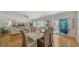 Spacious dining area with seating for six, seamlessly connecting to living spaces and patio access at 6512 Midnight Pass Rd # 206, Sarasota, FL 34242